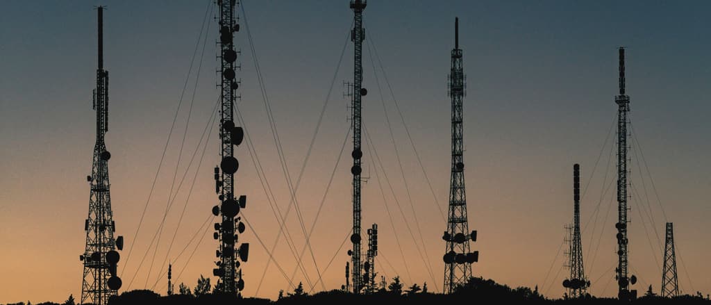 Telecommunication masts silhouetted against the dusk sky